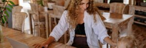 Photo of Woman Smiling While Sitting by the Table With Her Child