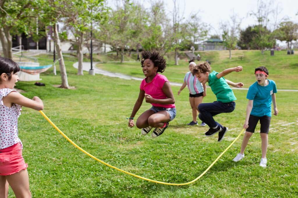 Kids playing jump rope in a park