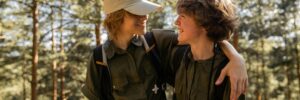 Smiling Boy Scouts Hugging in Forest