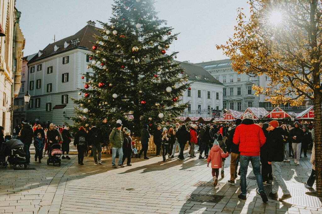 Festive Christmas Market Crowd in Sunlit Square