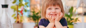 Toddler Smiling at table