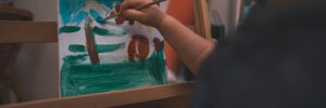 A Person Holding a Paint Brush Painting