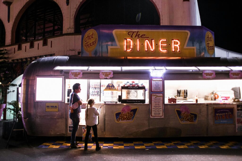 Father and Daughter Standing at Diner