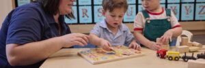 Kids learning from teacher around a table