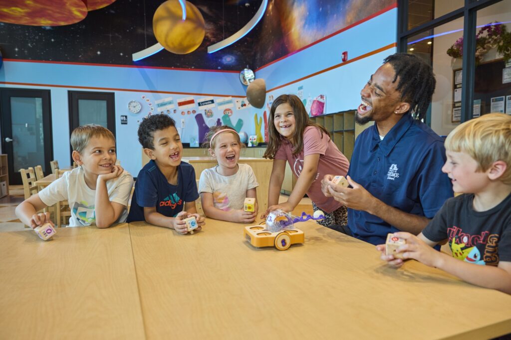 Children around a table with teacher