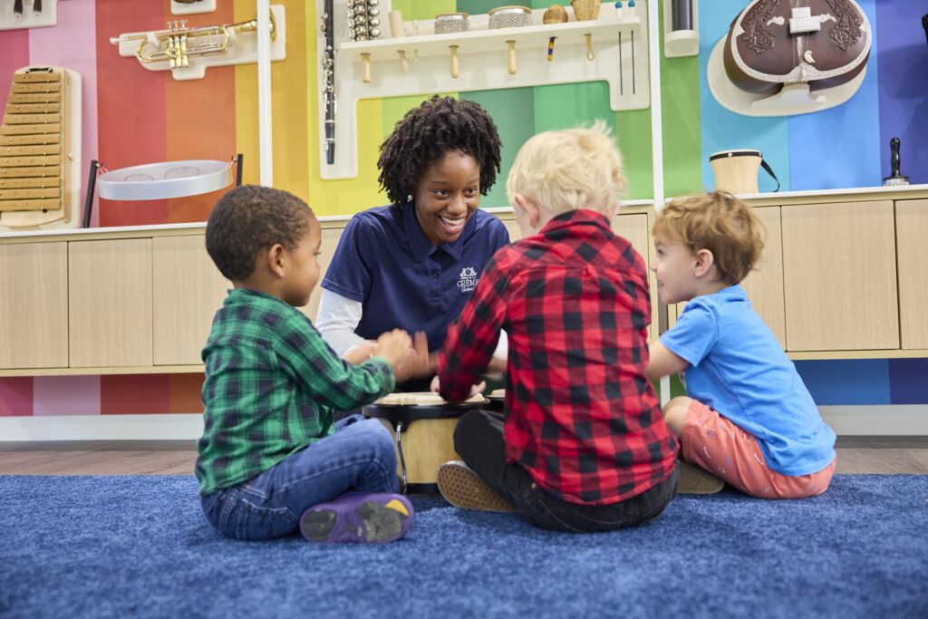 Teacher with young students in a circle smiling