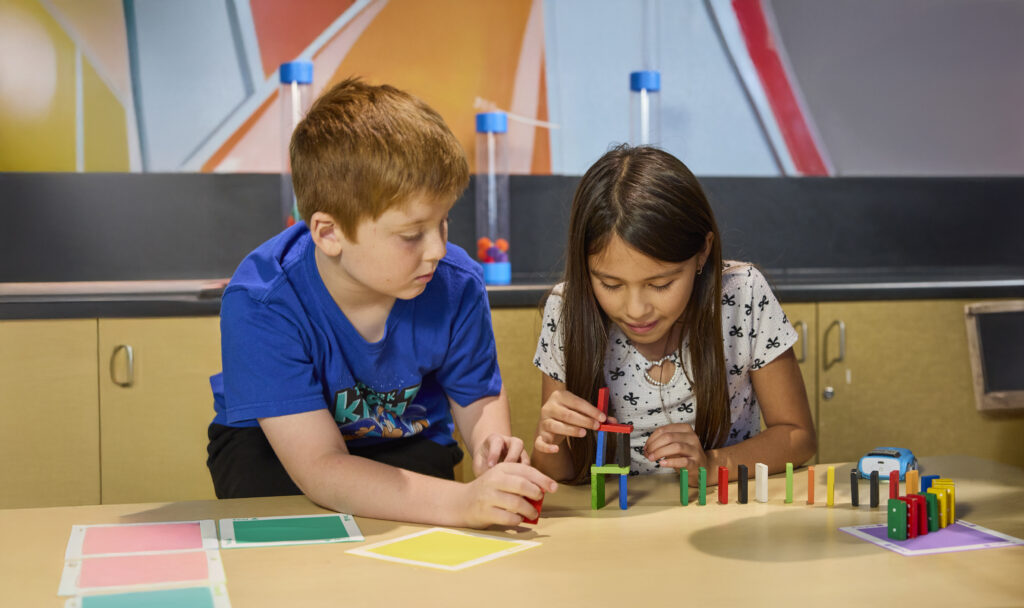 Two children at school stacking blocks