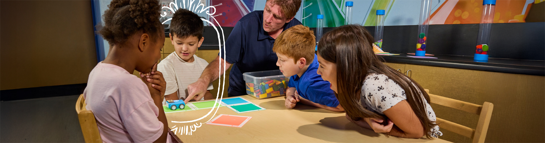 A child holding a puppet, made during an arts class as part of the Crème de la Crème before and after school program.