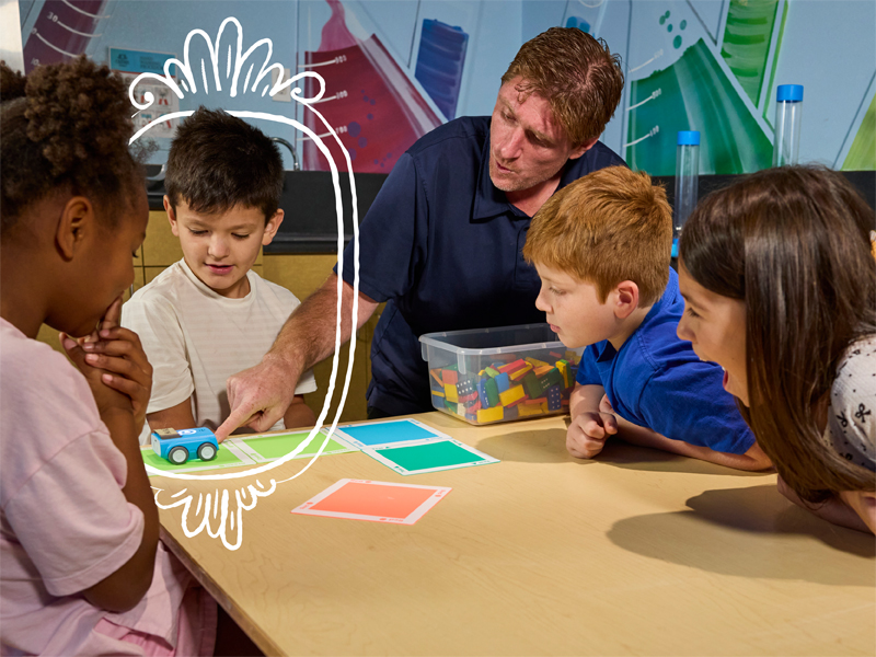 A child holding a puppet, made during an arts class as part of the Crème de la Crème before and after school program.