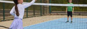 Two children playing paddleball