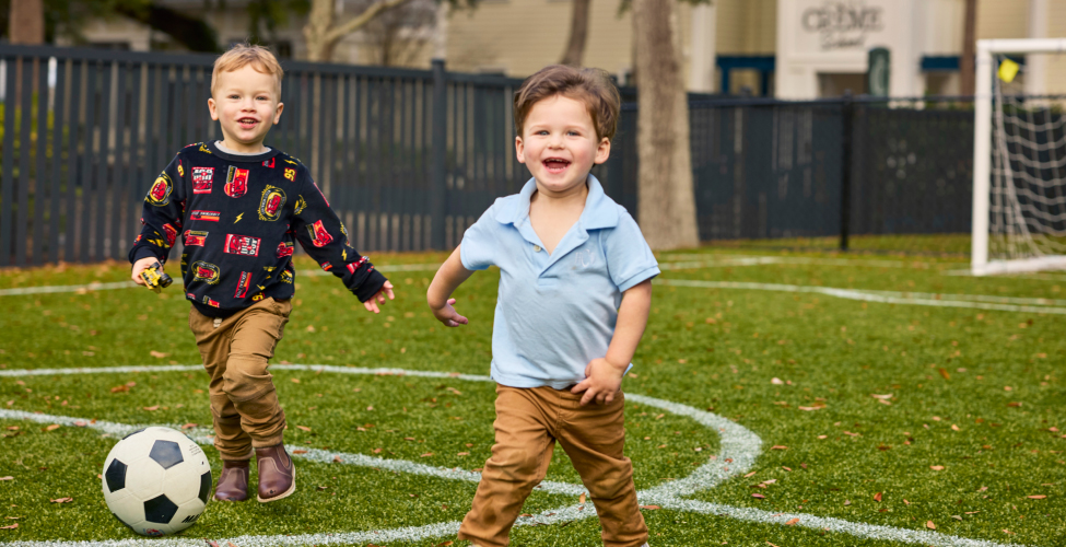 Toddlers playing soccer at a Creme de la Creme daycare