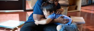 Teacher hugging student