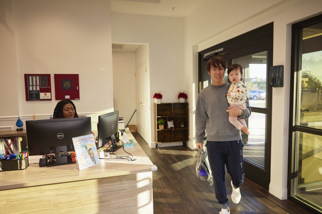 Man dropping off child at daycare before work