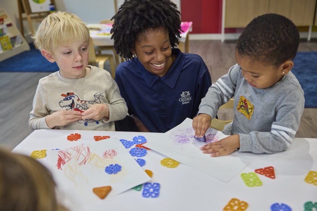 Teacher and two students painting and drawing